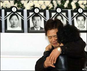 Family members console each other at the family support centre