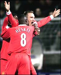 A delighted Sami Hyypia is congratulated by his team-mates on his 73rd-minute goal