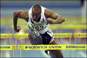 Great Britain's Colin Jackson on his way to first place in 60m hurdles 