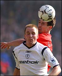 Bolton's Henrik Pedersen and Manchester United's Gary Neville compete for the ball