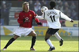 Ricardo Gardner of Bolton takes the ball past David Beckham 