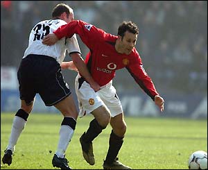 Ryan Giggs tries to get away from Simon Charlton