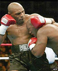 Mike Tyson pounds Clifford Etienne in the first round of their heavyweight fight 