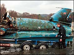 Remains of Bluebird being towed from Coniston Water