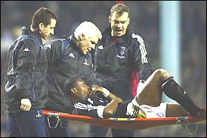 Martin Djetou of Fulham is carried off on a stretcher after 12 minutes