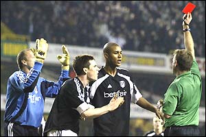 Maik Taylor throws his hands in the air in disbelief as referee Graham Barber shows him a red card