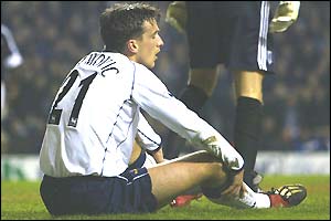 Milenko Acimovic of Tottenham sits on the ground after missing an easy goalscoring chance