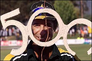 Pakistan's Wasim Akram holds a 500 cut-out presented to him by his team mates for his world record 500th one-day wicket