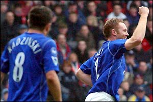 Everton's Tomasz Radzinski looks on as team-mate Steve Watson celebrates scoring the opening goal of the game