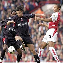 Charlton's Mark Fish holds off Thierry Henry of Arsenal 