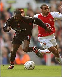 Arsenal's Thierry Henry and Chris Powell of Charlton Athletic chase the ball 