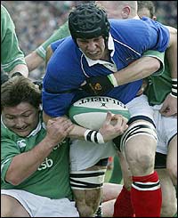 France's Imanol Harinordoquy is tackled by Irish hooker Shane Byrne 