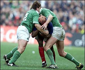 Ireland's James Byrne and Gary Longwell tackle France's Serge Betsen