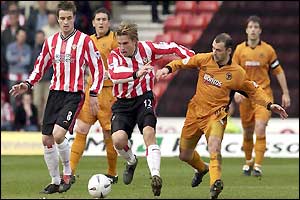 Anders Svensson and Cameron battle for the ball