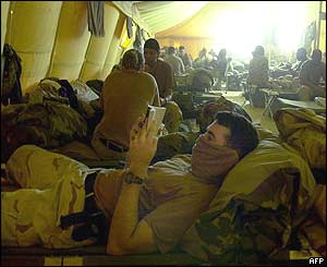 Capt. Gabe Marriott, attached to the US Army�s 101st Airborne Aviation Brigade, reads a book while resting in a tent at Camp Udairi in northern Kuwait