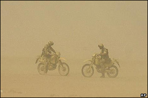 Soldiers out on motorbikes during a sandstorm