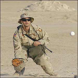 Army handout photo of 101st Airborne Division soldier playing baseball in the desert