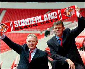 Howard Wilkinson and Steve Cotterill hold a Sunderland scarf aloft as they are announced as the new managerial team at the Stadium of Light