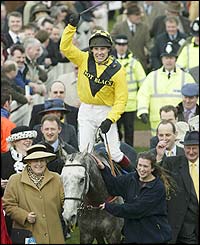 Jockey Richard Johnson punches the air in delight after riding Rooster Booster to an easy win in the Champion Hurdle