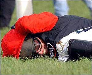 Tony McCoy protects his head after falling from Le Roi Miguel in the Challenge Trophy 