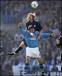 Birmingham midfielder Robbie Savage climbs above Manchester City's Kevin Horlock