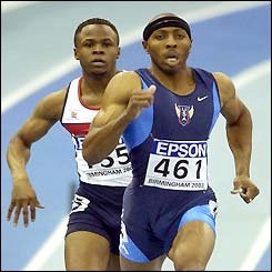 Tyree Washington runs ahead of Daniel Caines in the 400m