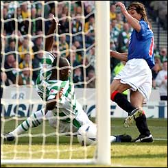 Claudio Cannigia beats Bobo Balde to the ball and scores for Rangers