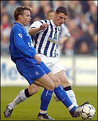 Chelsea's Graeme Le Saux is put under pressure by West Brom midfielder Jason Koumas