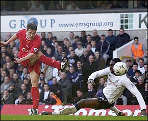 Michael Owen's shoots as Ledley King tries to block but the England striker levels the scores
