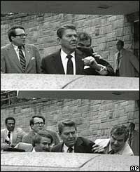 Reagan is pushed into his car by Secret Service agents 