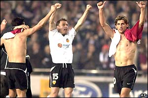 Valencia's players raise their arms to the crowd after the final whistle, celebrating their win