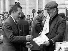 Man buying paper from news seller