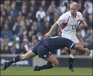 Scotland's Andrew Mower tries to tackle Neil Back