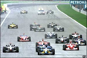 Renault driver Fernando Alonso of Spain, centre, leads the pack 