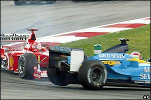 Michael Schumacher puts Jarno Trulli in a spin
