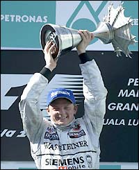 Raikkonen collects the winner's trophy