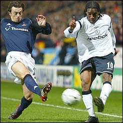 Spurs midfielder Simon Davies tries to prevent Jay-Jay Okocha from crossing
