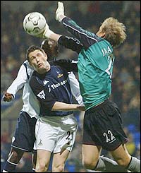 Tottenham striker Robbie Keane jumps with Bolton keeper Jussi Jaaskelainen 