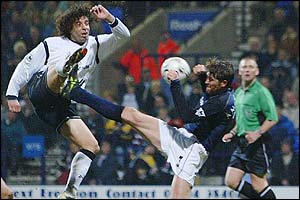 Bolton midfielder Ivan Campo shoots at goal but his effort is blocked by Darren Anderton's desperate challenge