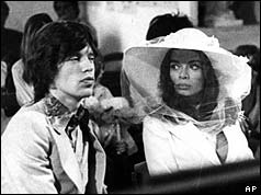 Mick and Bianca seated in a church pew