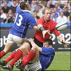 France's Thomas Castaignede tackles Wales' Gareth Taylor 