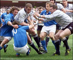 Scotland's Jason White battles through the Italian defence to score their first try