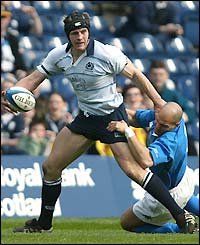 Scotland's Simon Taylor is tackled by Italy's Dennis Dallan