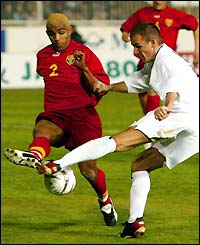 Aguinaldo Braga de Jesus of Macedonia and Slovakia's Robert Vittek battle for the ball as Slovakia head to a 2-0 win