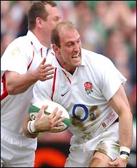 Lawrence Dallaglio celebrates his try