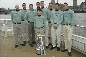 The Cambridge crew pose with the trophy on the banks of the Thames