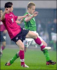 Albania's Adrian Aliaj challenges Damien Duff