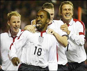 Vassell celebrates with his team-mates after putting England ahead against Turkey