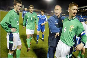 Northern Ireland boss Sammy McIlroy consoles his players