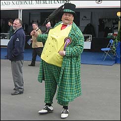 A colourfully dressed man enjoys his day at the races